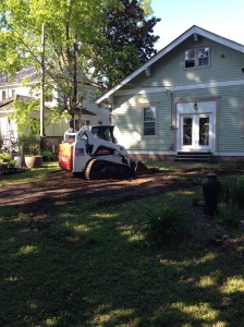 Removing soil in the back of the house.